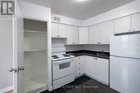 Toronto (Thorncliffe Park) condo for rent - A kitchen with white appliances and cabinets.