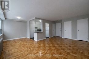 Toronto (Thorncliffe Park) condo for rent - A spacious room with wooden flooring and white walls.