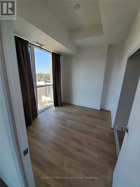Toronto (Don Valley Village) condo for rent - A room with a slanted ceiling and wooden flooring.