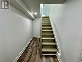 Markham (Berczy) apartment for rent - A staircase with wooden steps and a white wall on the side.