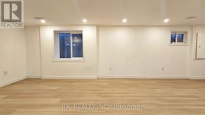 Mississauga (Malton) apartment for rent - A room with wooden flooring and a window with blinds.