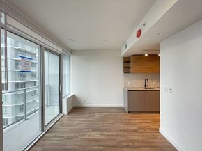 Surrey apartment for rent - A kitchen area with a sink and a window with a view of a building.