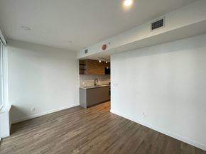 Surrey apartment for rent - A room with a kitchen area in the background.