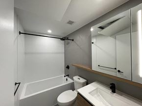 Surrey apartment for rent - A white bathroom with a toilet, sink, and bathtub.