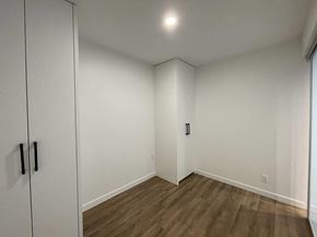 Surrey apartment for rent - A room with a white door and a brown floor.