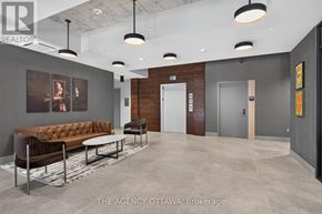 Ottawa condo for rent - A modern office lobby with a brown leather sofa and a grey carpet.