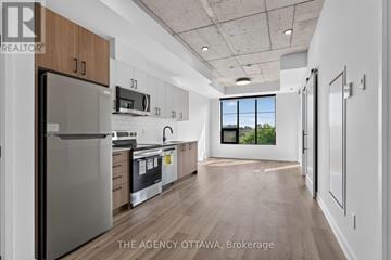 Ottawa condo for rent - A modern kitchen with wooden cabinets and stainless steel appliances.