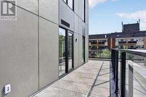 Ottawa condo for rent - A modern building with a balcony and glass doors.
