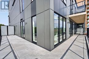 Ottawa condo for rent - A modern building with a glass facade and a concrete structure.