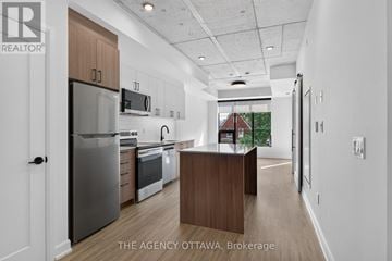 Ottawa condo for rent - A modern kitchen with a refrigerator, oven, and microwave.