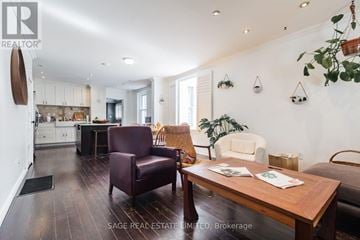Toronto (Greenwood-Coxwell) apartment for rent - A living room with a brown leather chair and a wooden table.