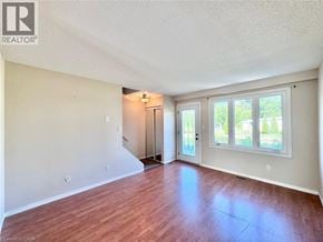 Cambridge townhouse for rent - A room with wood flooring and a sliding glass door leading to a backyard.