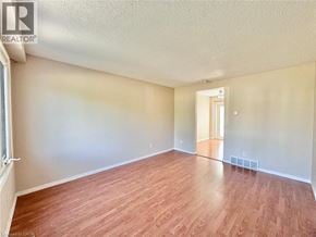 Cambridge townhouse for rent - A room with wooden flooring and a doorway leading to another room.
