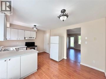 Cambridge townhouse for rent - A kitchen with white cabinets and a wooden floor.