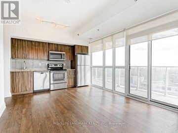 Oakville (Co Central) condo for rent - A spacious kitchen with wooden cabinets and stainless steel appliances.