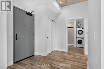 Ottawa condo for rent - A modern kitchen with a washer and dryer in the laundry room.