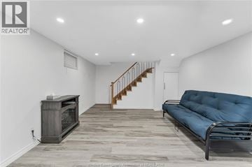 Windsor apartment for rent - A living room with a blue couch and a wooden floor.