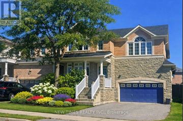 Vaughan (Vellore Village) apartment for rent - A house with a blue garage door is for sale.