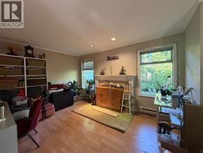 Burnaby townhouse for rent - A living room with a fireplace and a dining area.
