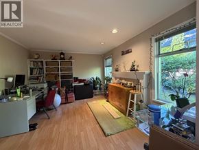 Burnaby townhouse for rent - A living room with a couch, chair, and a bookshelf.