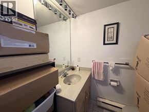 Burnaby townhouse for rent - A bathroom with a sink, mirror, and towel rack.