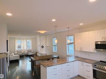 Edmonton apartment for rent - A modern kitchen with white cabinets and a granite countertop.