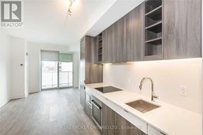 Toronto (Mount Pleasant West) condo for rent - A modern kitchen with a sink, stove, and cabinets.