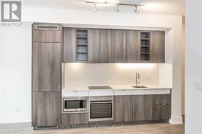Toronto (Mount Pleasant West) condo for rent - A modern kitchen with wooden cabinets and stainless steel appliances.