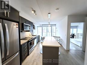 Toronto (Church-Yonge Corridor) condo for rent - A kitchen with a refrigerator, microwave, and oven.