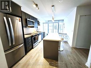 Toronto (Church-Yonge Corridor) condo for rent - A kitchen with a refrigerator, microwave, oven, and sink.
