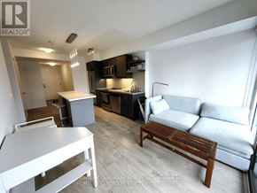 Toronto (Church-Yonge Corridor) condo for rent - A living room with a white couch and a wooden coffee table.