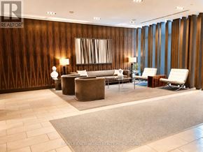 Toronto (Church-Yonge Corridor) condo for rent - A modern living room with a large mirror and a wooden wall.