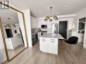 Toronto (Church-Yonge Corridor) condo for rent - A modern kitchen with a large mirror and a black chair.