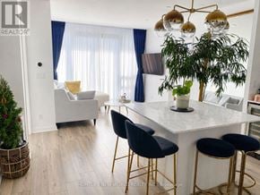 Toronto (Church-Yonge Corridor) condo for rent - A modern kitchen with a white countertop and gold bar stools.