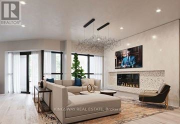 Toronto (Clairlea-Birchmount) condo for rent - A modern living room with a large couch, a fireplace, and a painting on the wall.