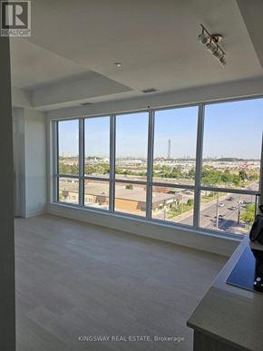 Toronto (Clairlea-Birchmount) condo for rent - A real estate brokerage office with a large window overlooking a cityscape.
