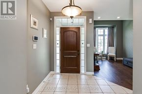 Burlington (Alton) apartment for rent - A hallway with a brown door and a chandelier.