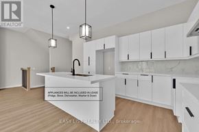 Thorold (Confederation Heights) fourplex for rent - A modern kitchen with white cabinets and a marble backsplash is on the market.