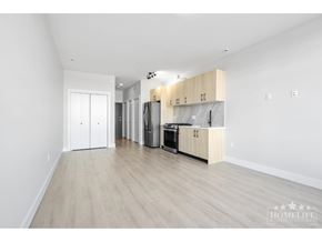 Surrey apartment for rent - A kitchen with white cabinets and a wooden countertop.