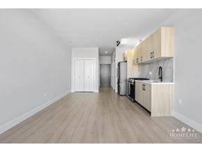Surrey apartment for rent - A kitchen with wooden floors and white walls.