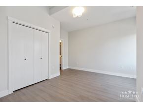 Surrey apartment for rent - A room with a white wall and a white closet with two doors.
