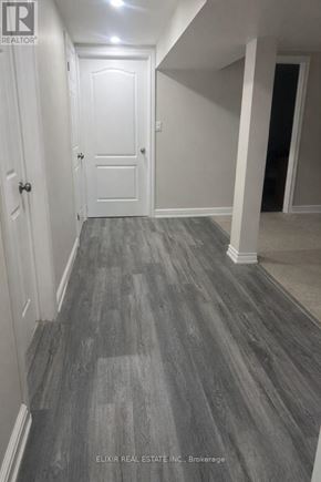 Burlington (Lasalle) apartment for rent - A hallway with a wooden floor and white walls.