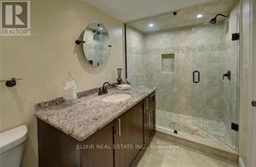 Burlington (Lasalle) apartment for rent - A bathroom with a marble countertop and a glass shower stall.