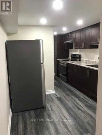Burlington (Lasalle) apartment for rent - A black refrigerator in a kitchen with wooden floors and white walls.