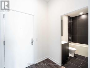 Toronto (Bay Street Corridor) condo for rent - A white bathroom with a black tiled shower area.