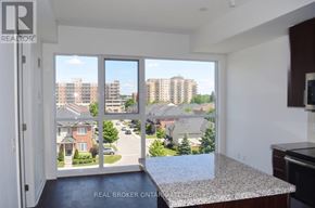 Burlington (Uptown) condo for rent - A view from a kitchen window looking out at a residential street.