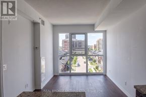 Burlington (Uptown) condo for rent - A real estate brokerage office with a view of a residential area outside.