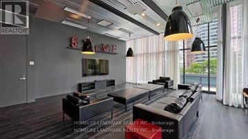 Toronto (Bay Street Corridor) condo for rent - A living room with a large couch and a flat screen TV.