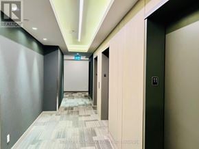Toronto (Don Valley Village) condo for rent - A hallway with a green door and a white door.