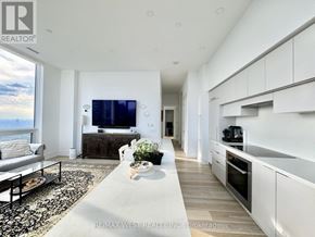 Toronto (Mount Pleasant West) condo for rent - A modern living room with a large television and a view of the mountains.